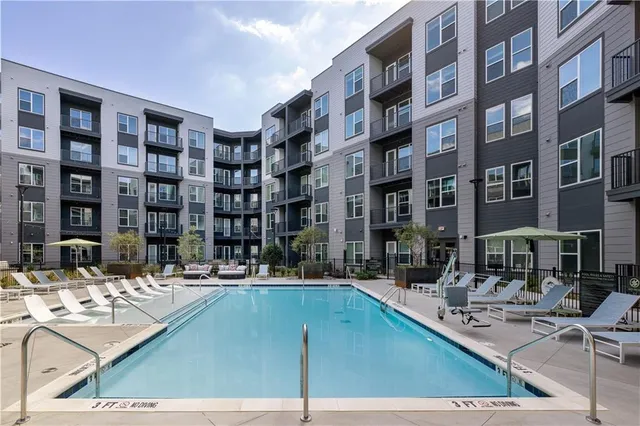 a building view with swimming pool and sitting space