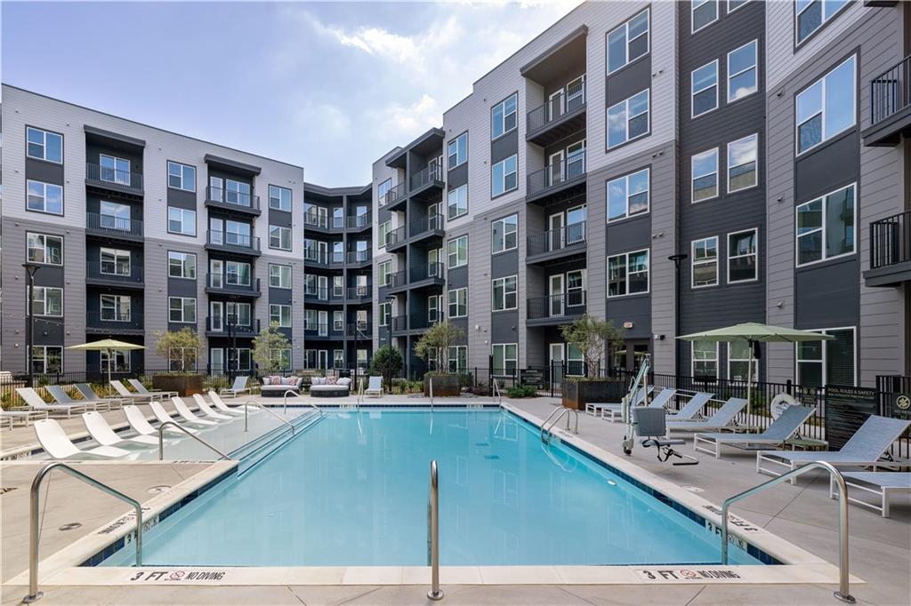 3108 McGinnis Ferry Road, Unit A6 Suwanee, GA 30024 - Photo 17 of 17 a building view with swimming pool and sitting space