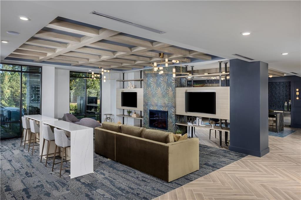 3108 McGinnis Ferry Road, Unit A6 Suwanee, GA 30024 - Photo 3 of 17 a living room with furniture and a flat screen tv