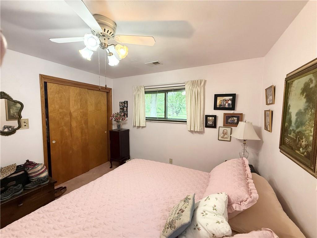 320 Saxonburg Road Butler, PA 16002 - Photo 19 of 36 a bedroom with a bed and a chandelier