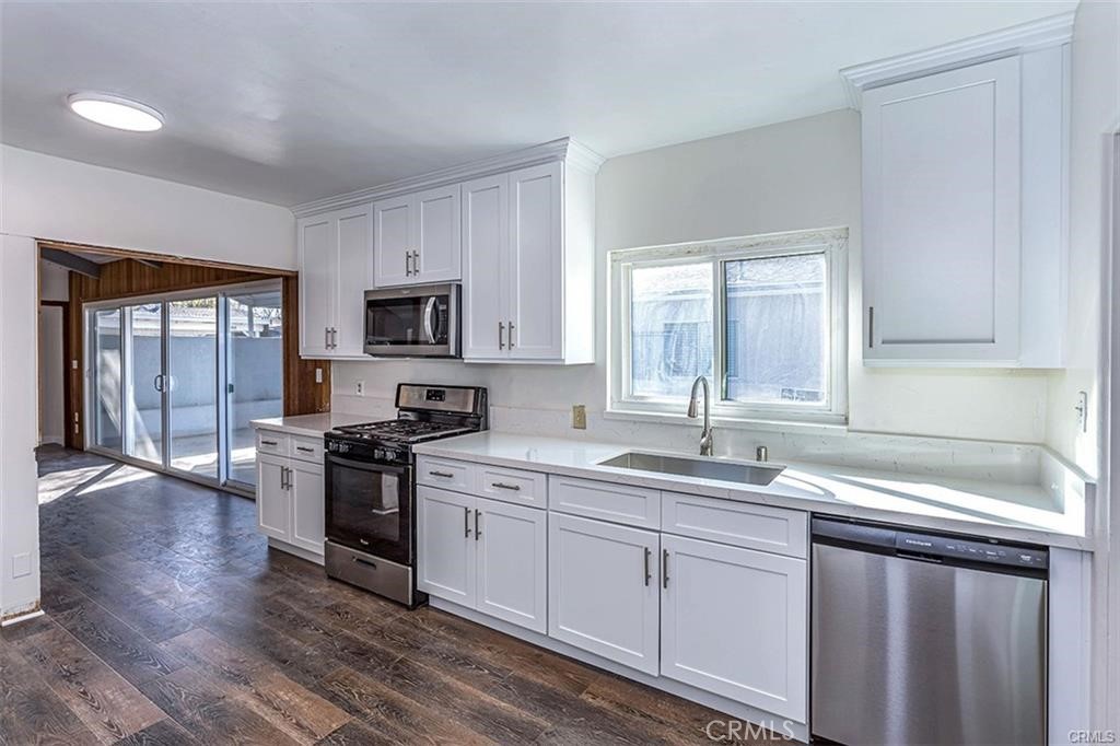 3454 Spruce Street Riverside, CA 92501 - Photo 6 of 6 a kitchen with granite countertop a sink stainless steel appliances and cabinets