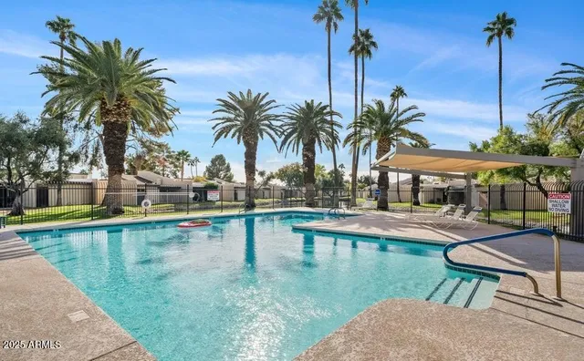 a view of a swimming pool with a table and chairs
