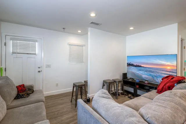 a living room with furniture and a kitchen view