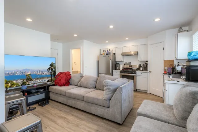 a kitchen with a table chairs refrigerator and microwave