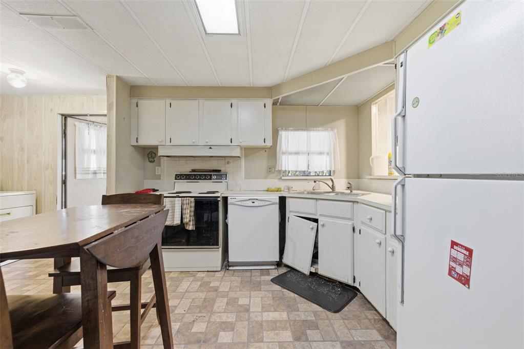 8045 Indian Trail Road Weeki Wachee, FL 34613 - Photo 12 of 49 a kitchen with granite countertop a sink appliances cabinets and counter space
