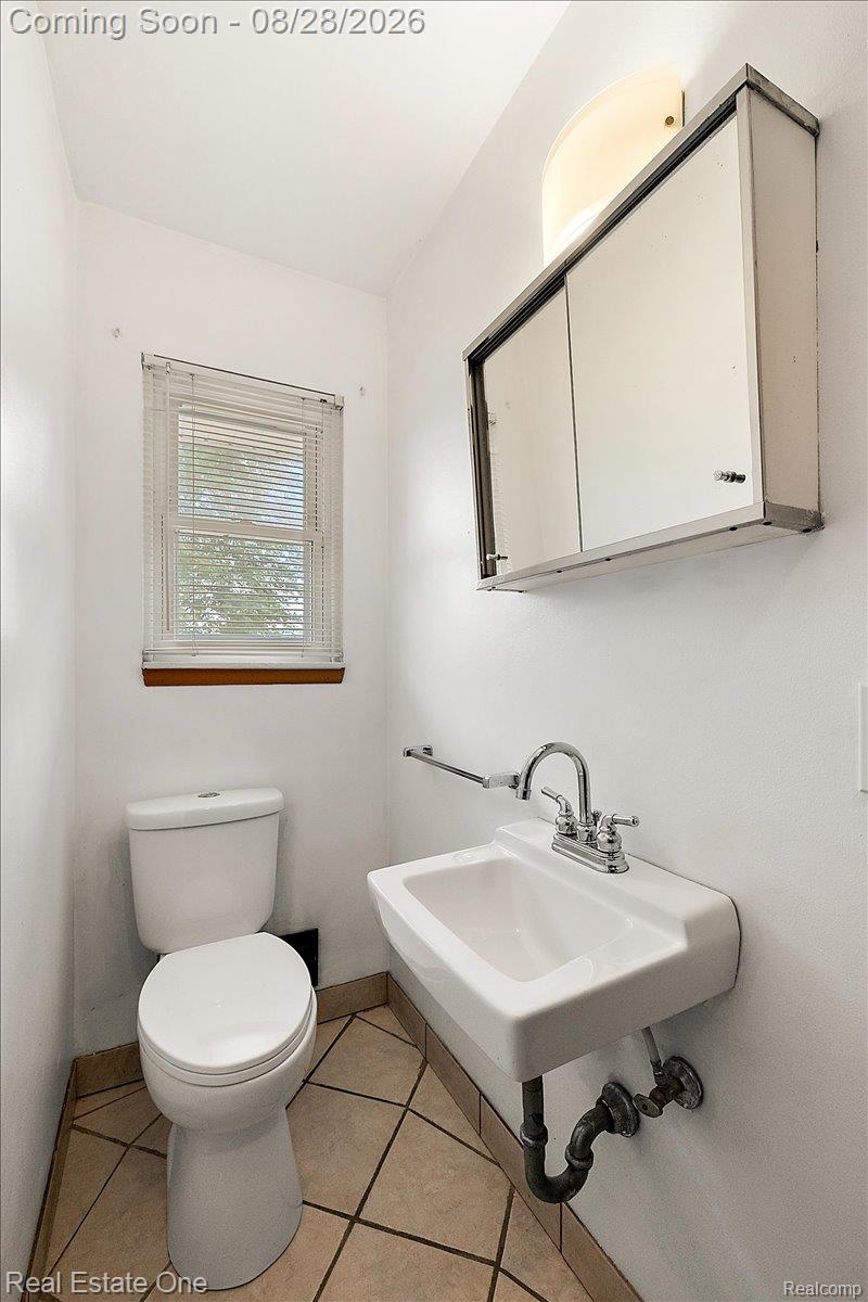 15250 34 Mile Road Armada, MI 48005 - Photo 33 of 49 White wall-mounted sink with chrome faucet, a mirrored medicine cabinet, and ceramic tile flooring