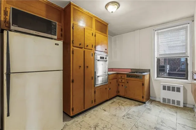 a kitchen with stainless steel appliances granite countertop a refrigerator and a stove