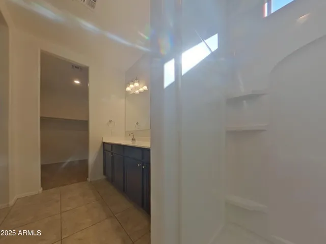 a bathroom with a double vanity sink and a mirror