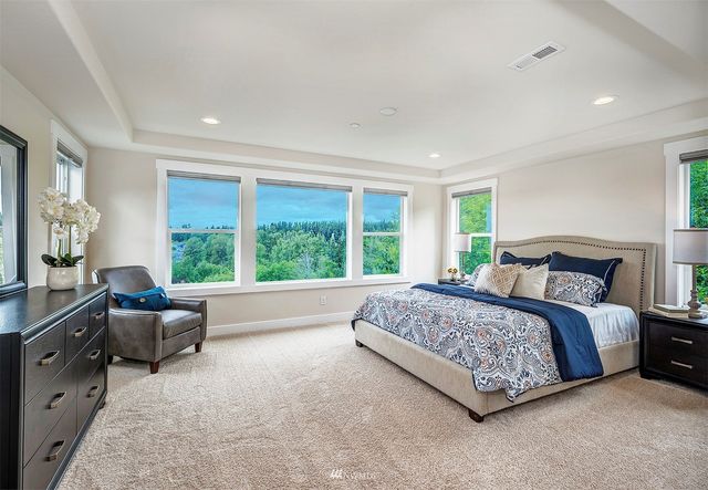 a spacious bedroom with a bed and a couch