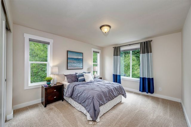 a spacious bedroom with a bed and a large window