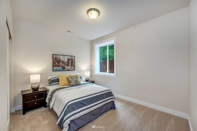 a bedroom with a bed and a night stand