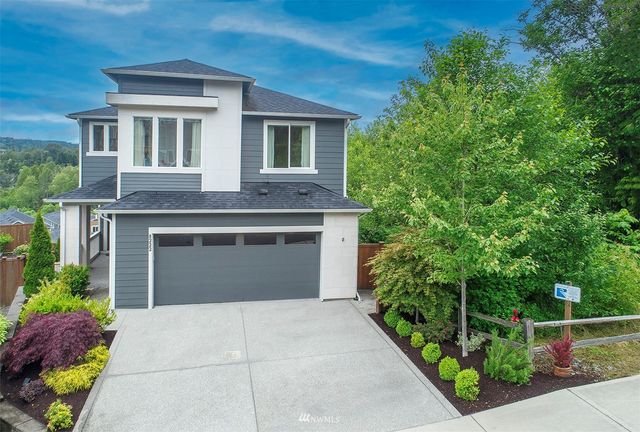 a front view of a house with plants