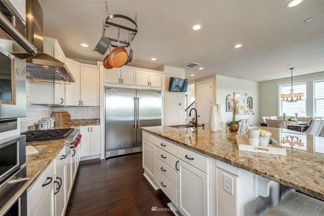 a kitchen with counter top space cabinets and stainless steel appliances