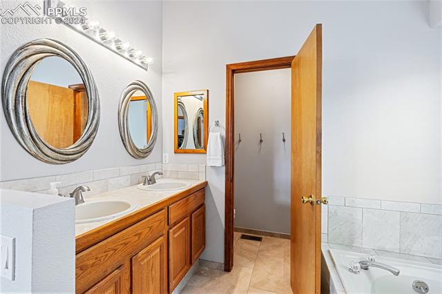 7510 Julynn Road Colorado Springs, CO 80919 - Photo 16 of 36 Primary bathroom has a large vanity with dual sinks