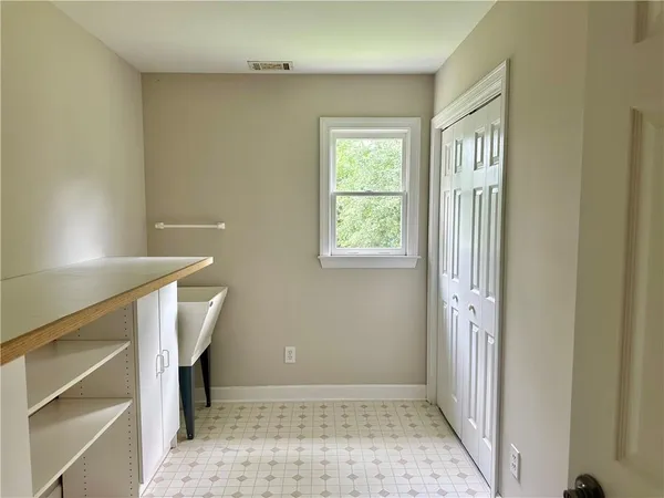 a view of an empty room with a window