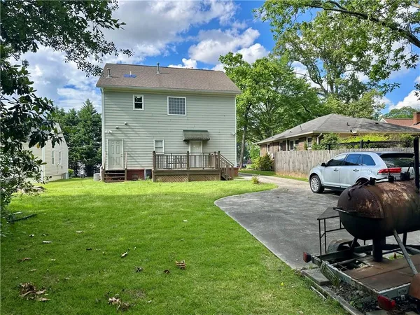 a view of a house with backyard tub and sitting area