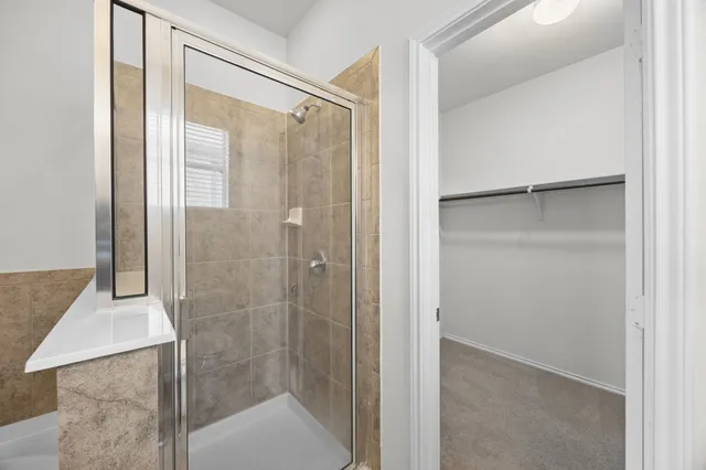 a bathroom with a glass shower door