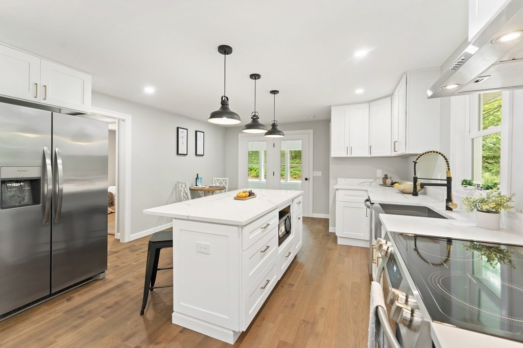 16 Chamberlain Road Shrewsbury, MA 01545 - Photo 12 of 38 a view of a kitchen with a stove a refrigerator and a sink