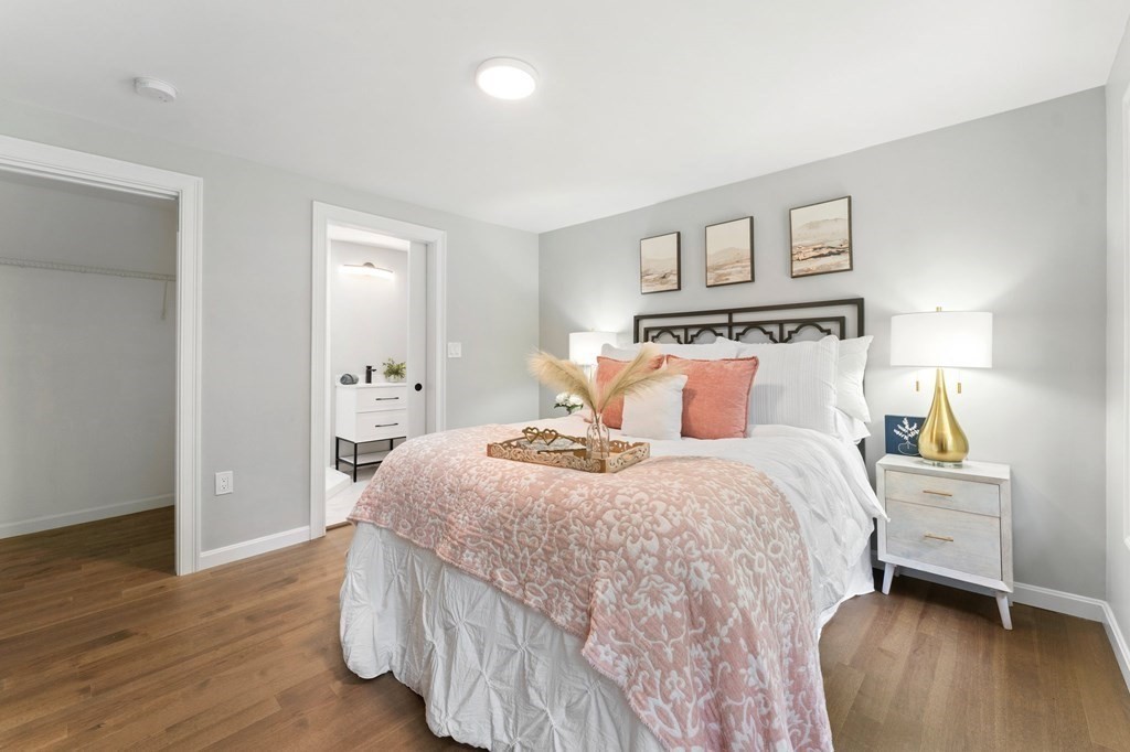 16 Chamberlain Road Shrewsbury, MA 01545 - Photo 20 of 38 a bedroom with a bed and wooden floor