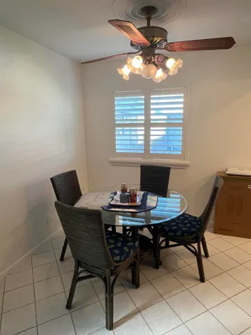 a view of a dining room with a table and chairs