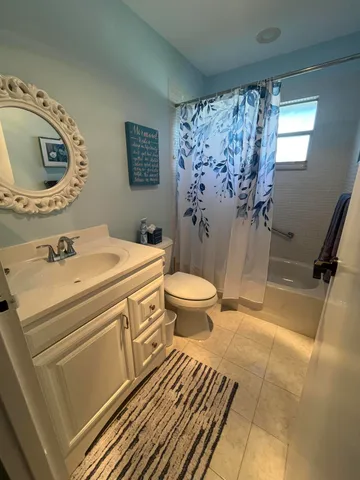 a bathroom with a sink toilet and a mirror