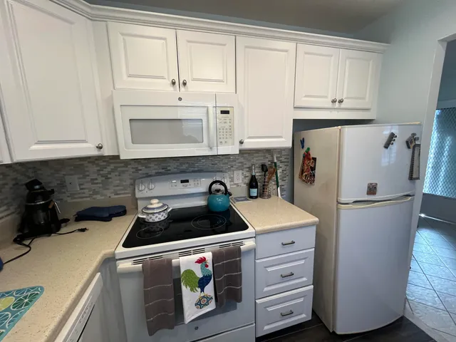 a kitchen with appliances a sink and cabinets