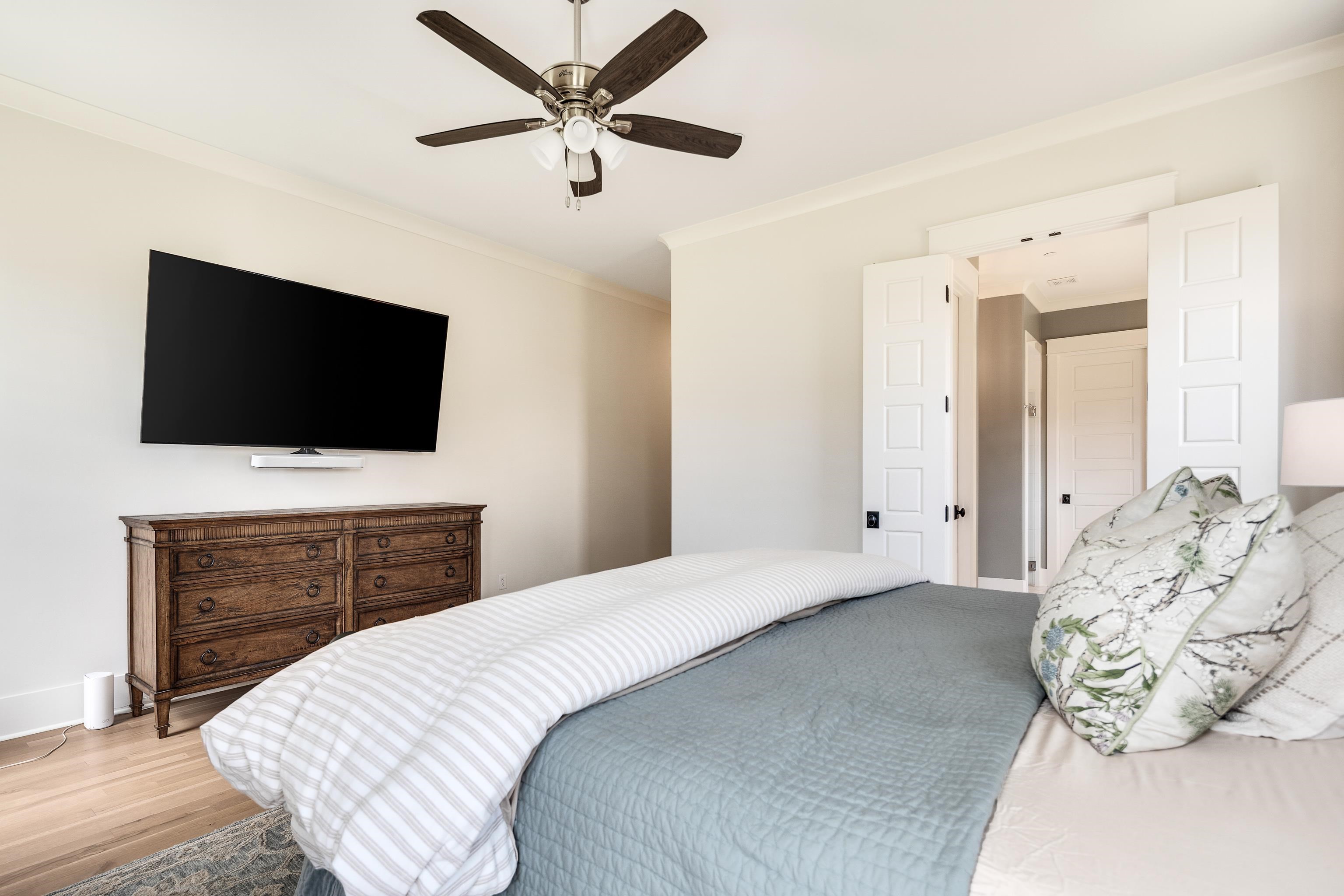 100 Sunflower View Road Piperton, TN 38017 - Photo 18 of 29 Bedroom featuring crown molding, light wood-finish flooring, and a ceiling fan with light fixture