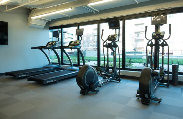 a living room with balcony table and windows