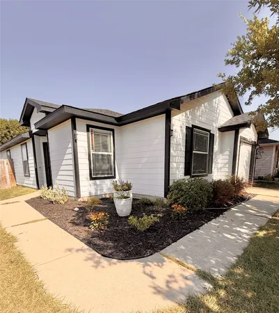 a front view of house with yard and trees around
