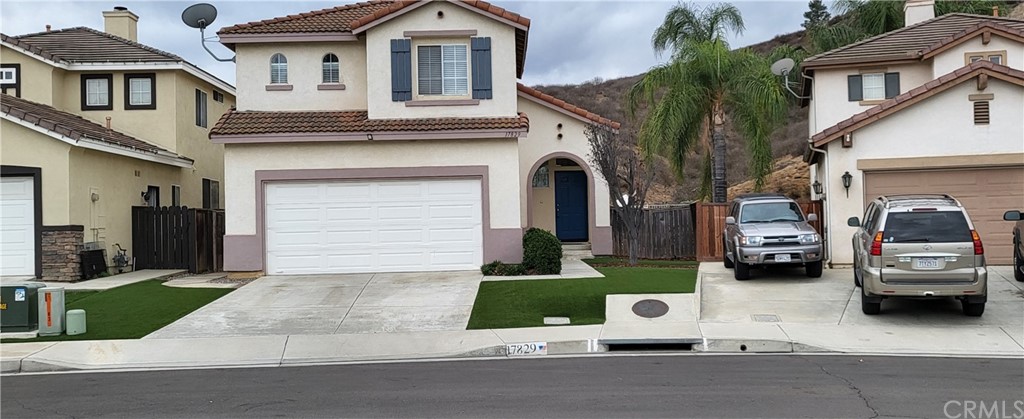 17829 Spring Hill Way Riverside, CA 92503 - Photo 1 of 1 a front view of a house with a garden and parking