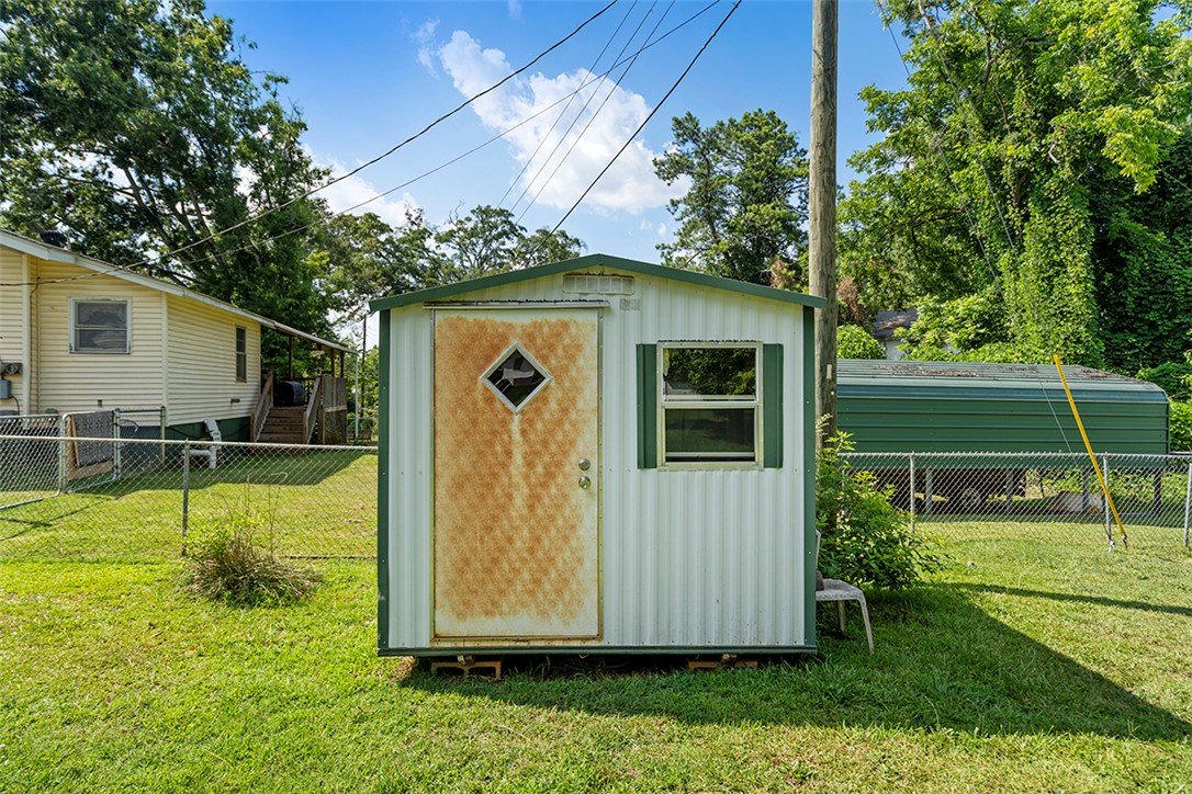 200 Louisiana Street Honea Path, SC 29654 - Photo 13 of 13 A quaint storage shed offers functional outdoor utility space for any homeowner.