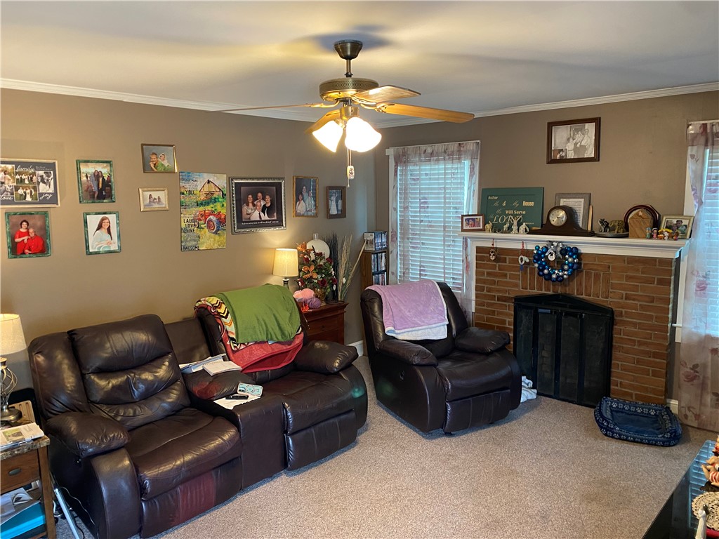 3 Heyward Avenue Honea Path, SC 29654 - Photo 11 of 35 This inviting living area features a classic brick fireplace, creating a warm and welcoming ambiance.