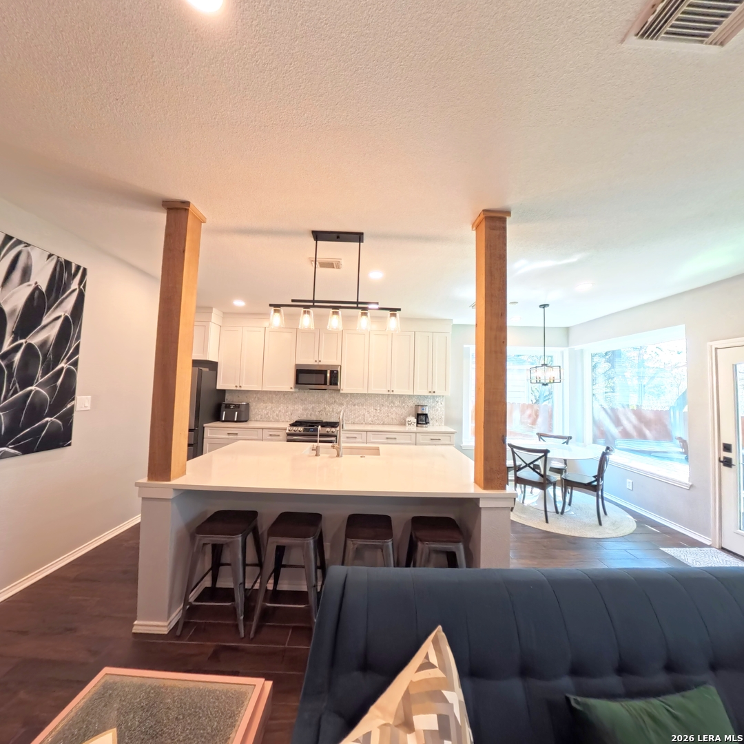 20115 Standish Road San Antonio, TX 78258 - Photo 14 of 51 a view of a dining room with furniture window and wooden floor