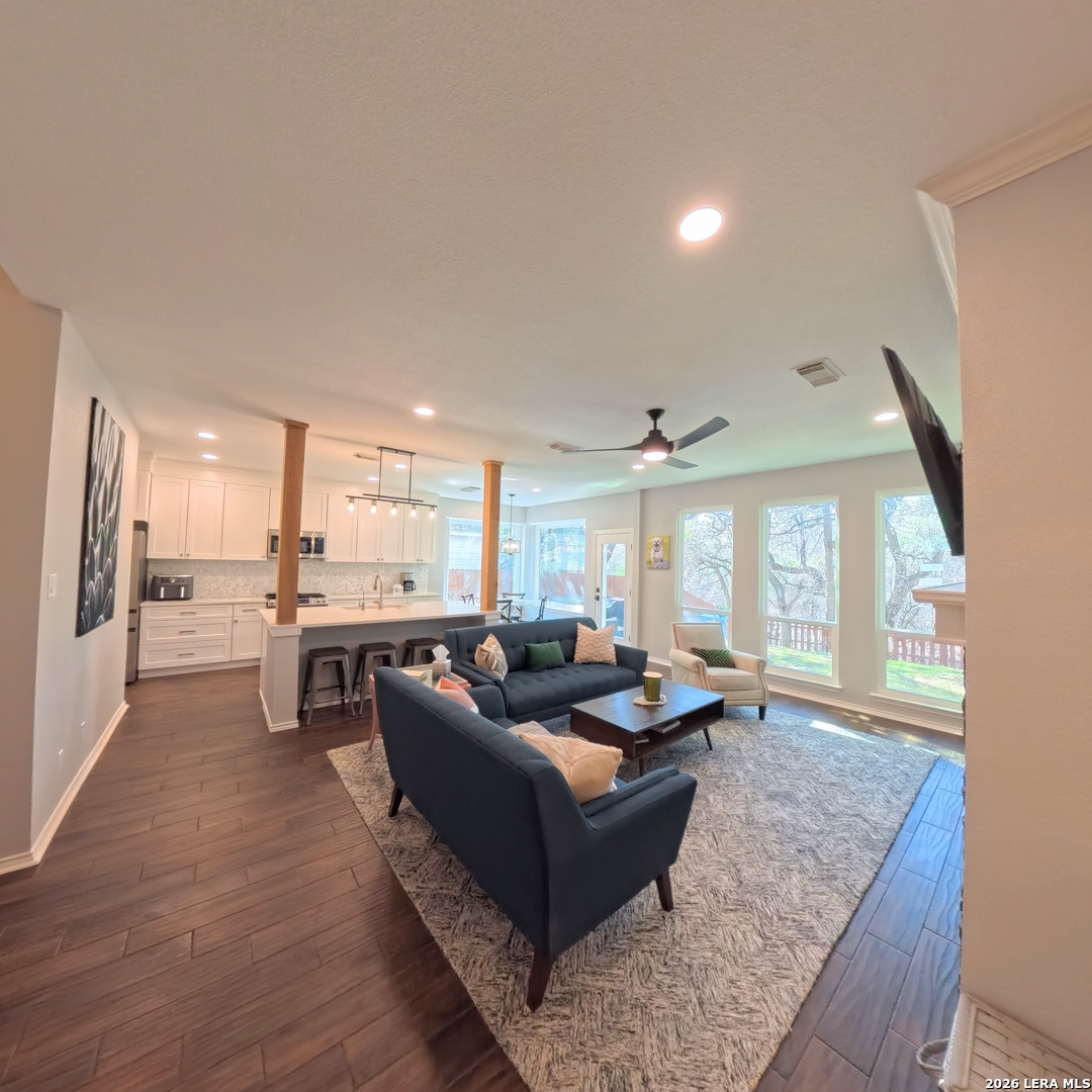 20115 Standish Road San Antonio, TX 78258 - Photo 15 of 51 a living room with couches and kitchen view with wooden floor