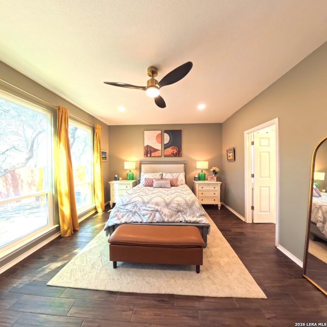20115 Standish Road San Antonio, TX 78258 - Photo 18 of 51 a bedroom with a bed and wooden floor