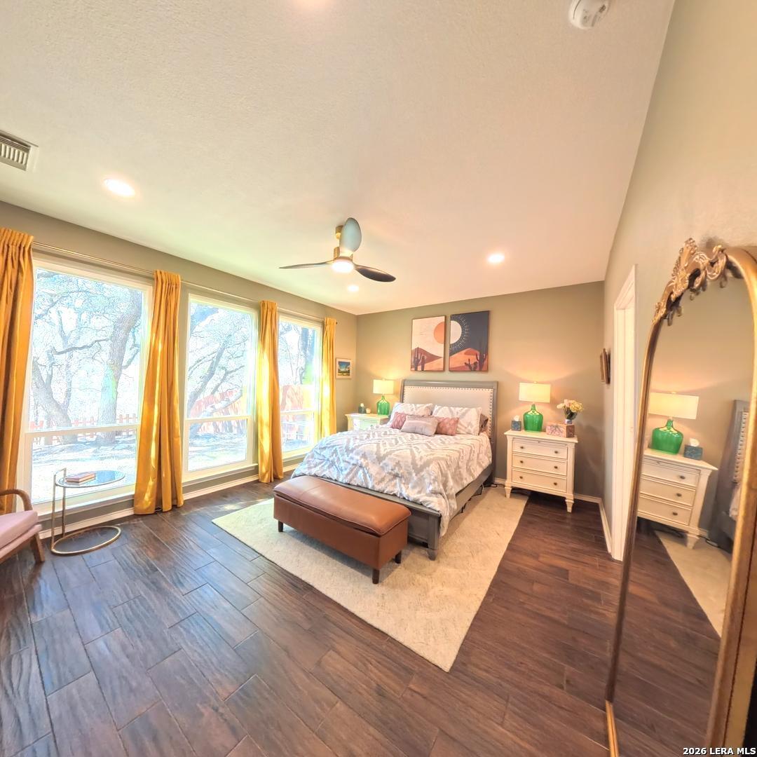 20115 Standish Road San Antonio, TX 78258 - Photo 19 of 51 a spacious bedroom with a bed and a large window