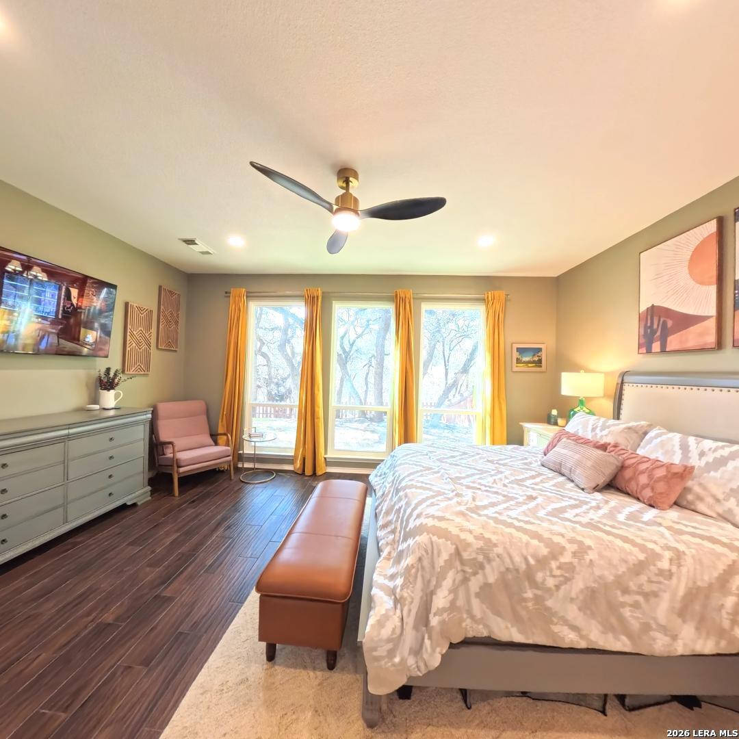 20115 Standish Road San Antonio, TX 78258 - Photo 20 of 51 a spacious bedroom with a bed and a large window