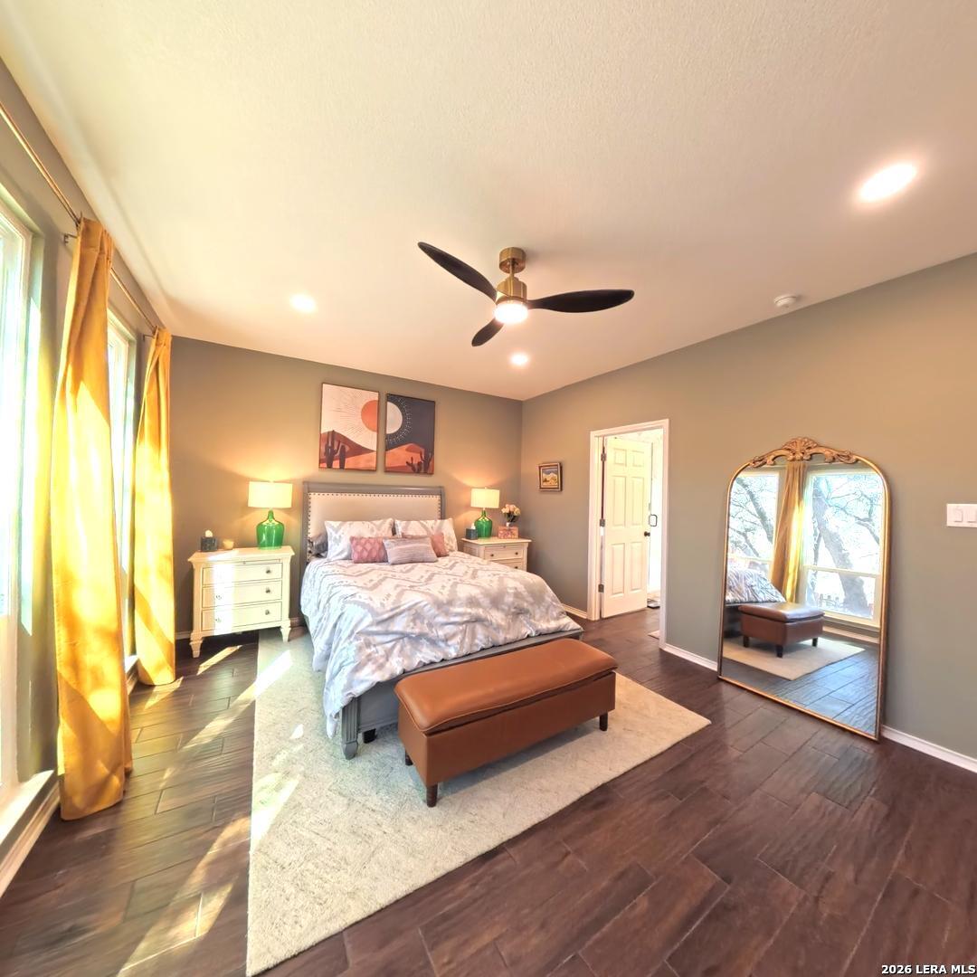 20115 Standish Road San Antonio, TX 78258 - Photo 21 of 51 a bedroom with a large bed and a large window