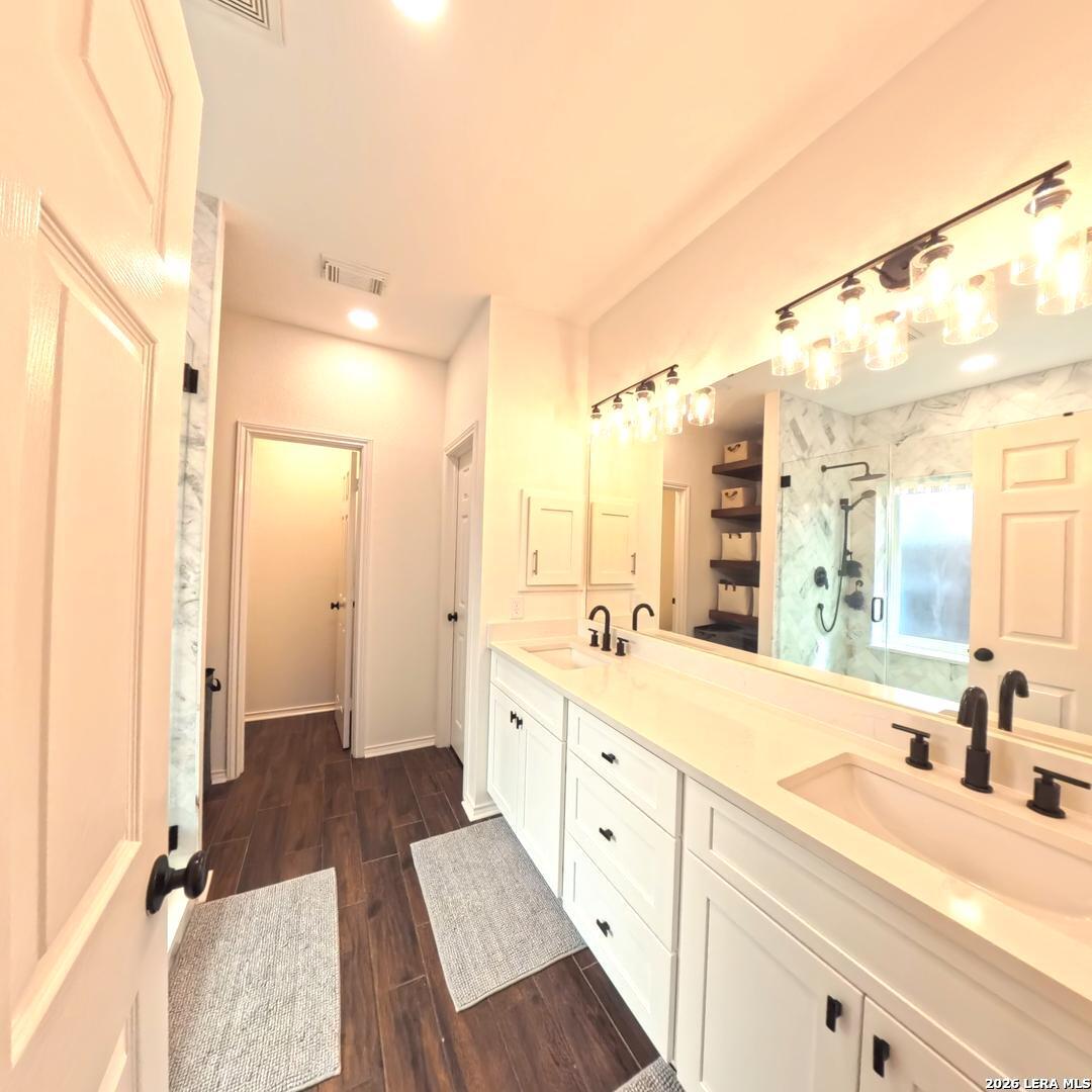 20115 Standish Road San Antonio, TX 78258 - Photo 22 of 51 a large bathroom with a tub sink and mirror