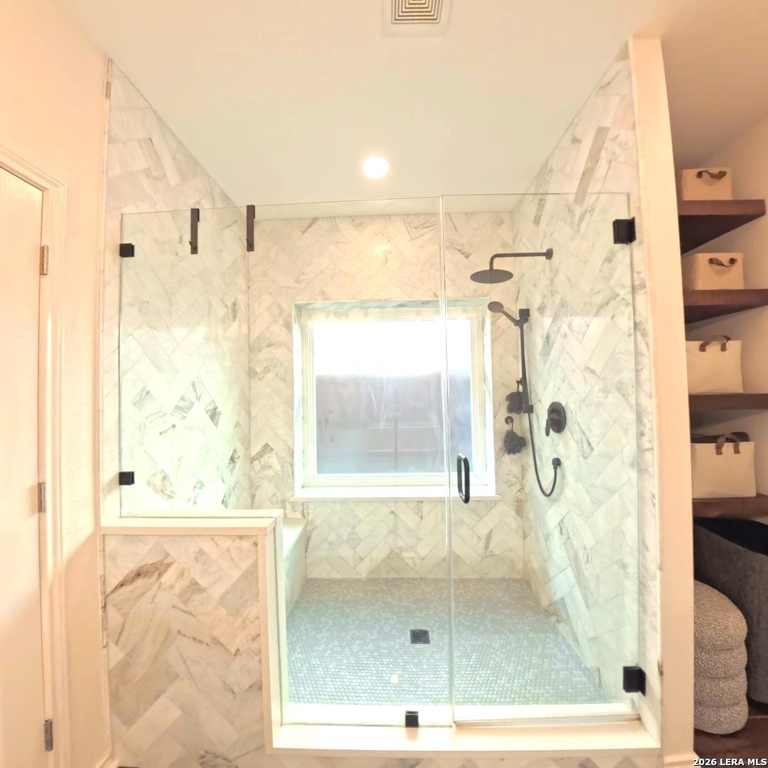 20115 Standish Road San Antonio, TX 78258 - Photo 24 of 51 a bathroom with a glass shower door