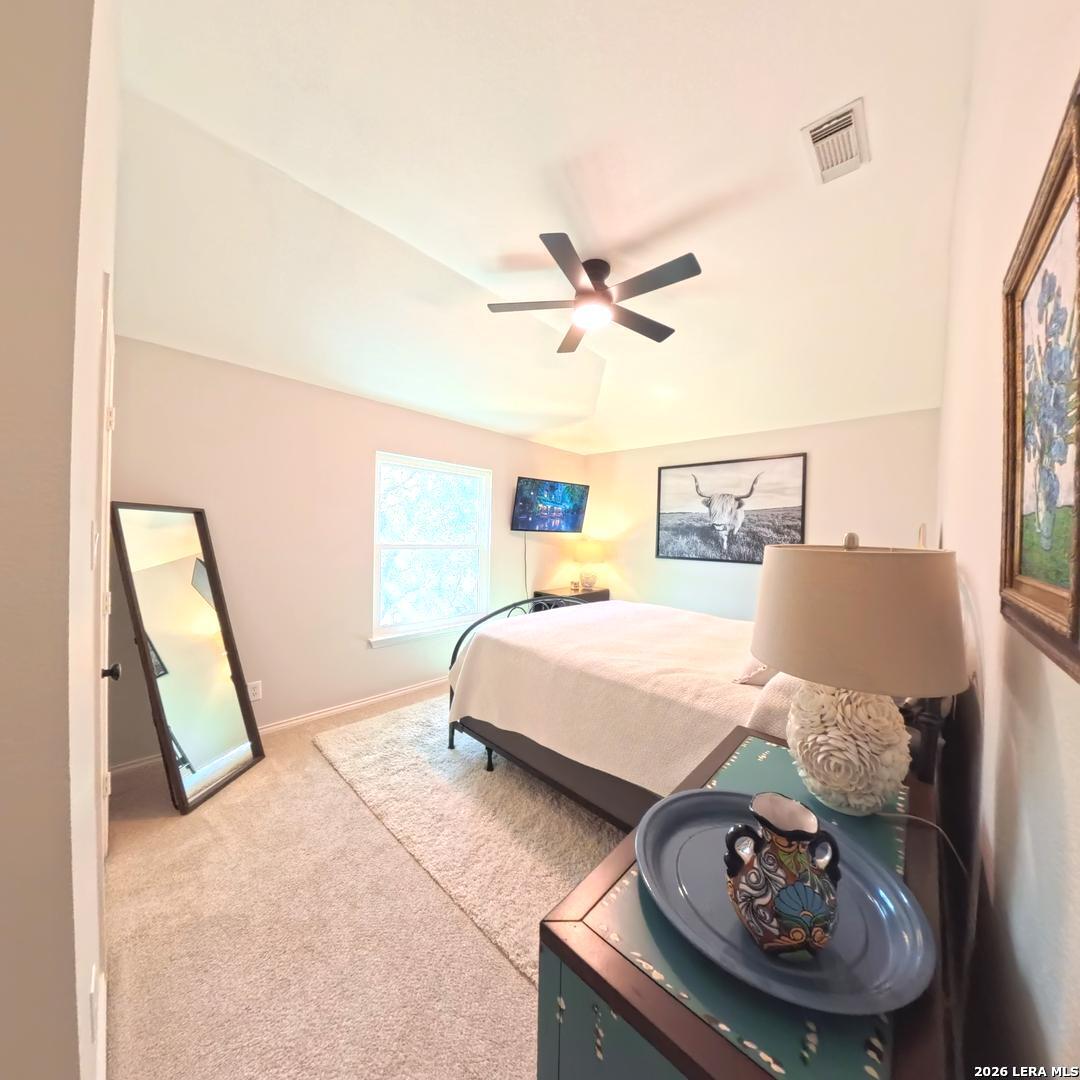 20115 Standish Road San Antonio, TX 78258 - Photo 42 of 51 a bed room with a bed a couch and a window