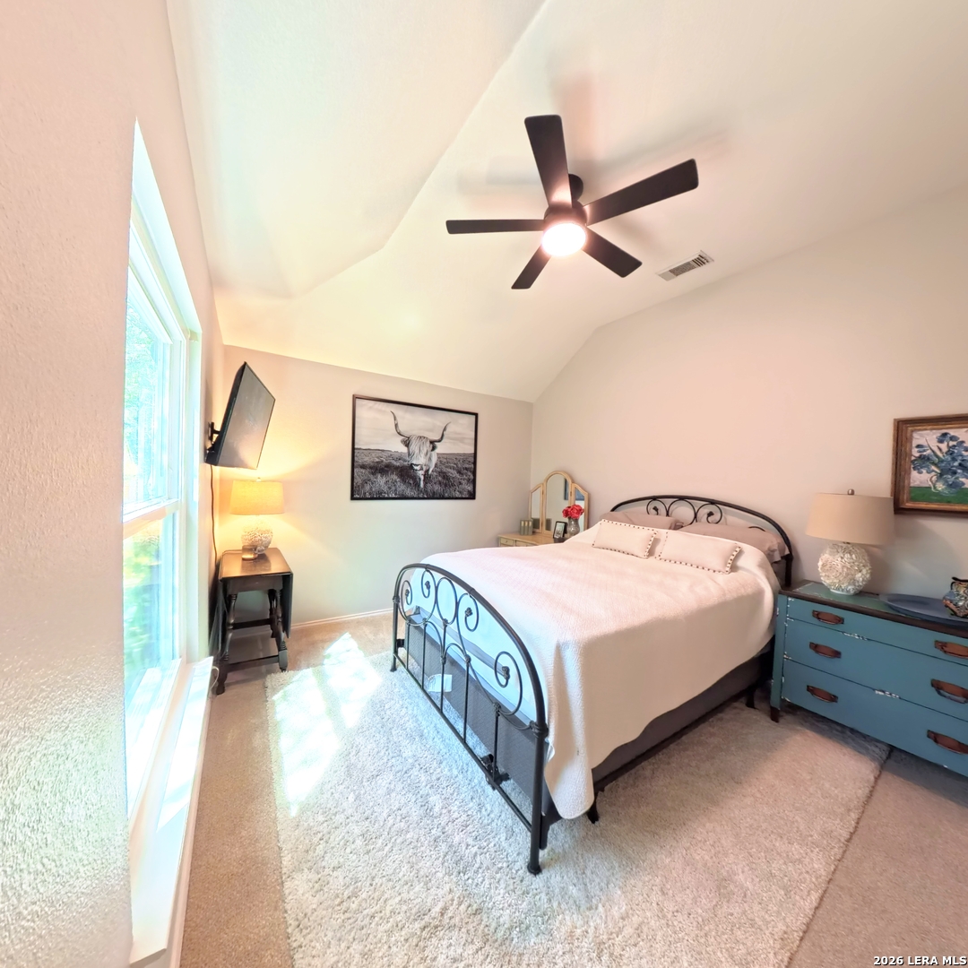 20115 Standish Road San Antonio, TX 78258 - Photo 43 of 51 a spacious bedroom with a bed and a painting on the wall