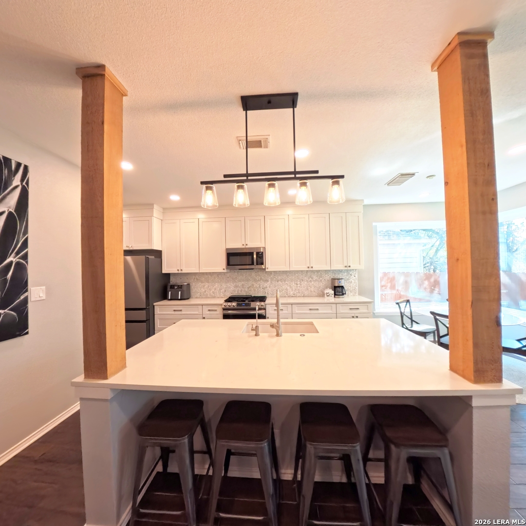 20115 Standish Road San Antonio, TX 78258 - Photo 7 of 51 a dining room with stainless steel appliances a table and chairs