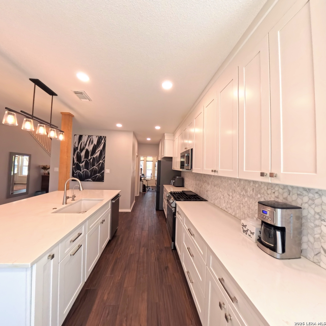 20115 Standish Road San Antonio, TX 78258 - Photo 9 of 51 a large kitchen with a large counter top a sink a window and stainless steel appliances