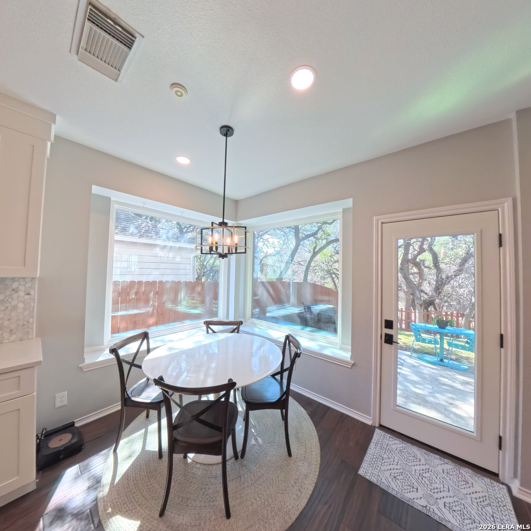 20115 Standish Road San Antonio, TX 78258 - Photo 10 of 51 a view of a dining room with furniture wooden floor and chandelier