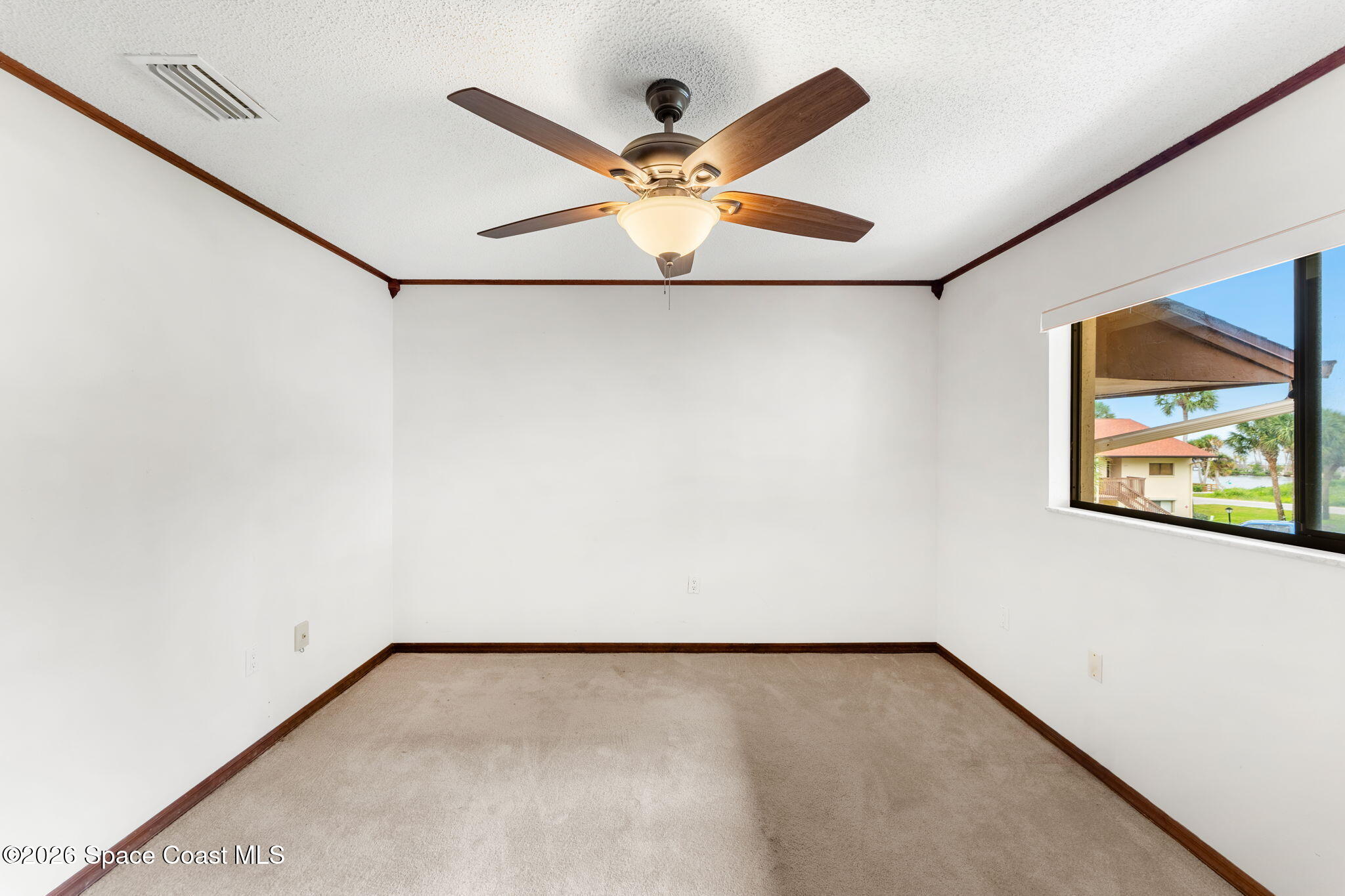 3121 Kirkland Road Northeast Palm Bay, FL 32905 - Photo 26 of 52 an empty room with a window and a ceiling fan