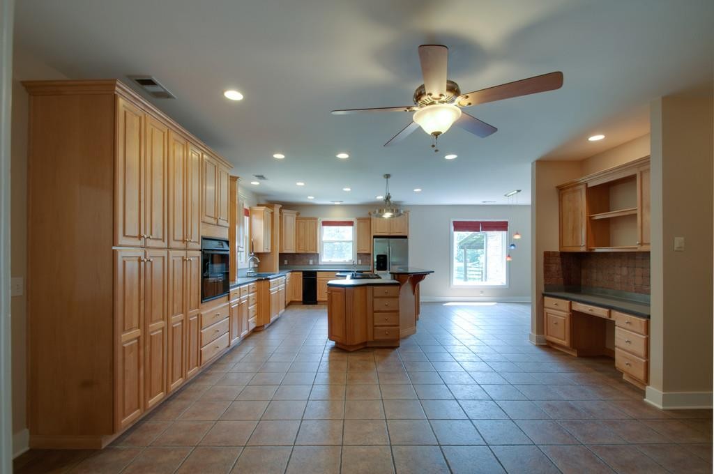 7155 Kingston Road Fairview, TN 37062 - Photo 5 of 6 a kitchen with stainless steel appliances kitchen island granite countertop a refrigerator and a sink