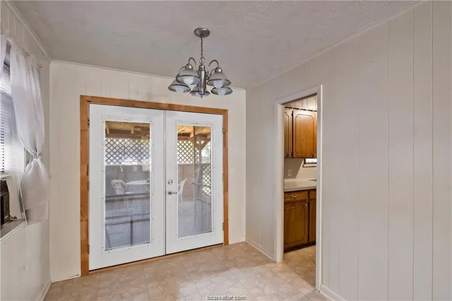 a view of a hallway with a chandelier