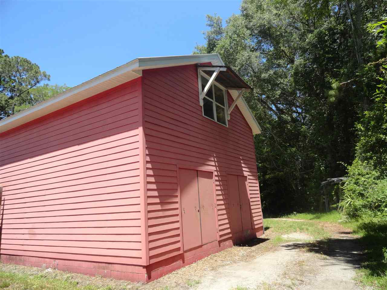 1340 Kings Estate Road St. Augustine, FL 32086 - Photo 1 of 40 a view of a wooden house with a yard