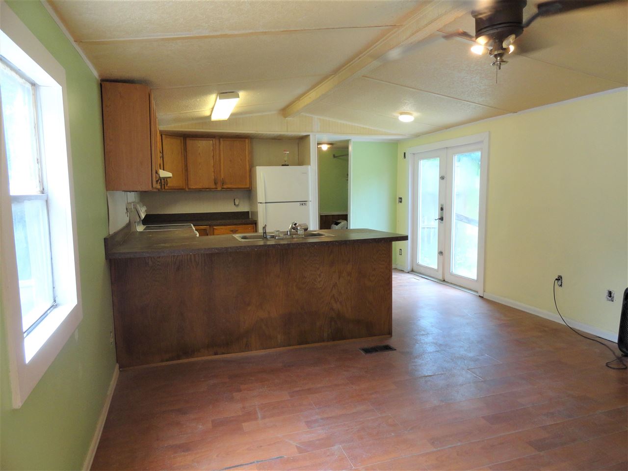 1340 Kings Estate Road St. Augustine, FL 32086 - Photo 28 of 40 a view of a kitchen with kitchen island a sink wooden floor and a counter top space